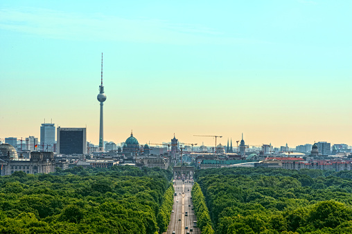 Berlin silhouette in vintage look - Brandenburger Tor, Strasse des 17. Juni, Fernsehturm (TV tower), Dom and some more visible. In foreground the green Tiergarten