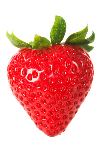 A ripe strawberry with leaves isolated against a white backgorund