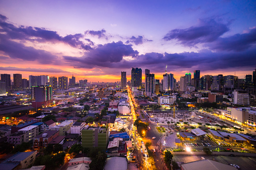 Manila city at Twilight showing Makati City, Ortigas and suburban buildings and the Capital Commons building development site in the foreground