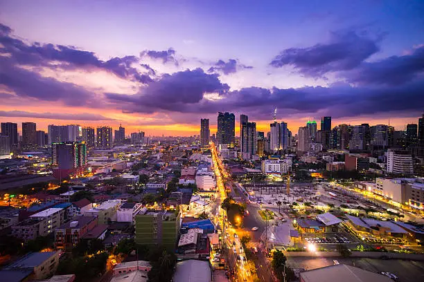 Manila city at Twilight showing Makati City, Ortigas and suburban buildings and the Capital Commons building development site in the foreground