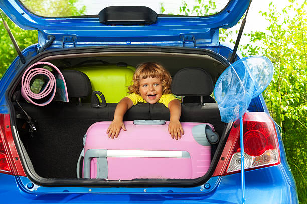 istock Happy boy with bags in the car 478359651