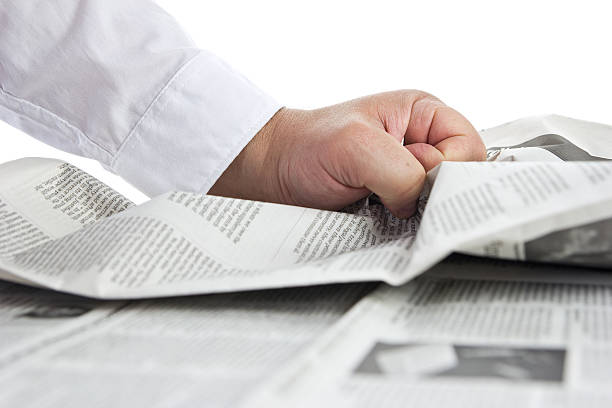 istock Bad news. Hand crumpling a newspaper. 478360308