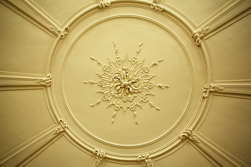 Old antique plaster ceiling plate or rose in an old victorian house