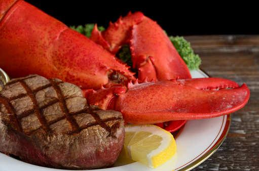 Gourmet surf and turf dinner - a freshly boiled New England lobster and a grilled filet mignon steak.