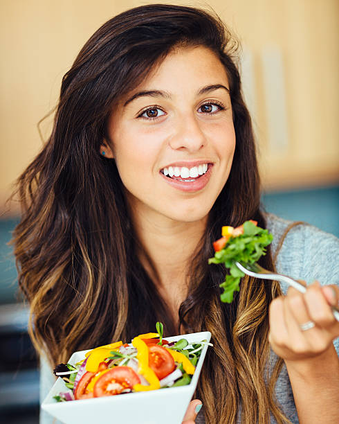 istock Woman eating salad 478369219