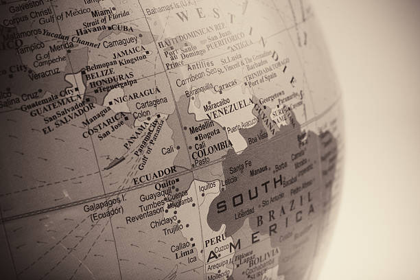 Macro of a recycled glass marble globe with internal bubbles and surface imperfections and shallow depth of field showing south america.