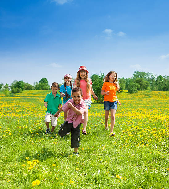 мальчики и девочки, running - playing field sport friendship happiness стоковые фото и изображения