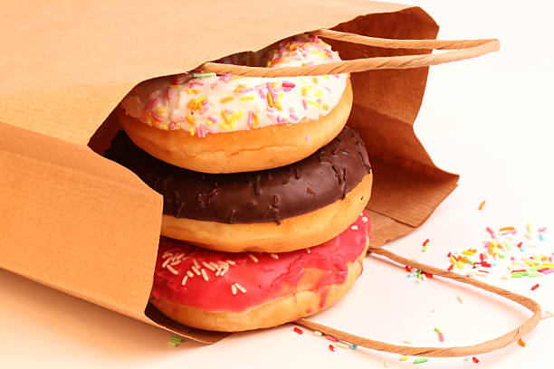 istock Fried donuts in a paper shopping bags 478377404