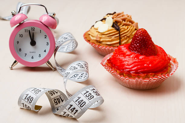 istock Sweet food measuring tape and clock on table 478377752