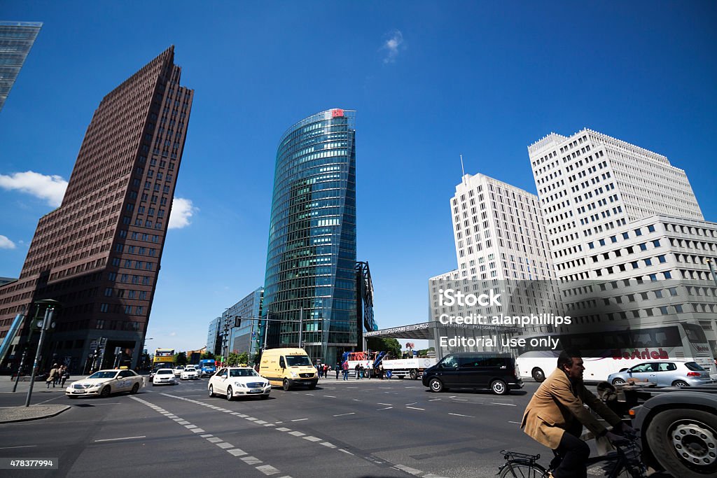 Skyscrapers and traffic at Potsdamer Platz Berlin Germany Berlin, Germany - June 17, 2015: Skyscrapers and traffic at a busy intersection at Potsdamer Platz, Berlin, Germany. Potsdamer Platz once stood at the Berlin Wall between East and West Berlin and was mostly vacant after heavy bombing during World War II. Since the fall of the Berlin wall in 1989 it has been the site of a major construction of modern buildings. 2015 Stock Photo