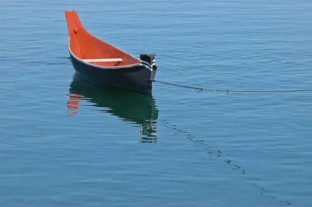 rowing boat floats on calm lake