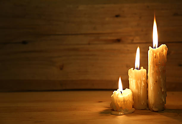 istock Burning old candle on wooden vintage background 478384772