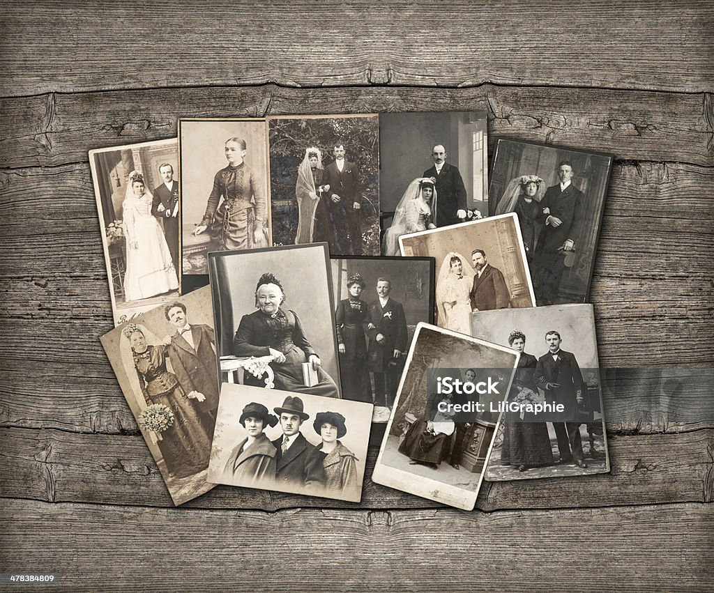 Old family photos laid out on wooden background group of vintage family and wedding photos circa 1890-1920. nostalgic sentimental pictures on rustic wooden background Photograph Stock Photo