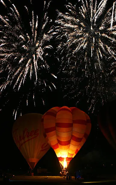 Hot air balloon nightglow with fireworks