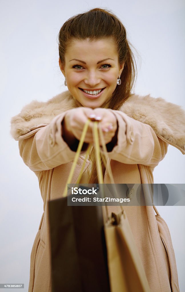 Portrait of stunning young woman carrying shopping bags Happy young woman with shopping bags at mall  http://azarubaika.com/iStockphoto/2013_02_17_Viktoria_Shopping_Mall.jpg 20-24 Years Stock Photo