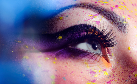 macro shot of woman with blue eye and makeup.