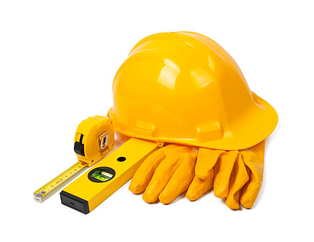 hard hat, leather gloves and tools stock photo