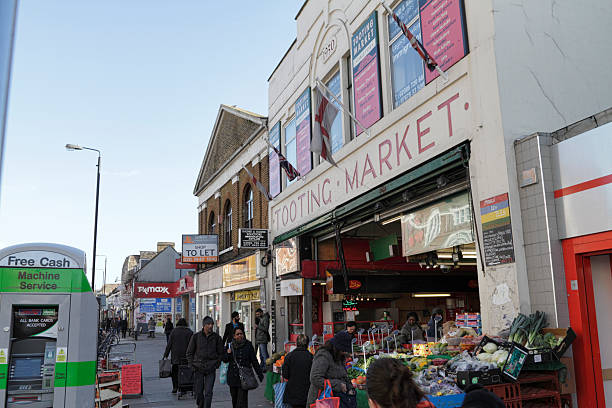 Tooting Broadway Market London SW17 exterior The Broadway Market, across the road from Tooting Broadway Underground Station in London SW17, houses over 100 traders in a large building. Between them, the traders represent many nationalities and sell many different goods, from fruit and saris to luggage. brixton photos stock pictures, royalty-free photos & images