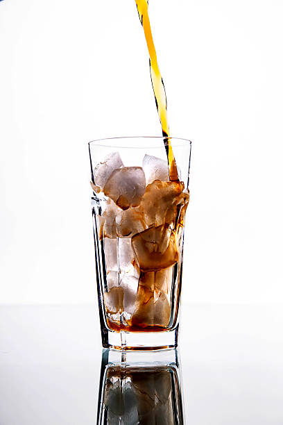 istock soft drinks. Cola Pour From Bottle to Glass 478389044