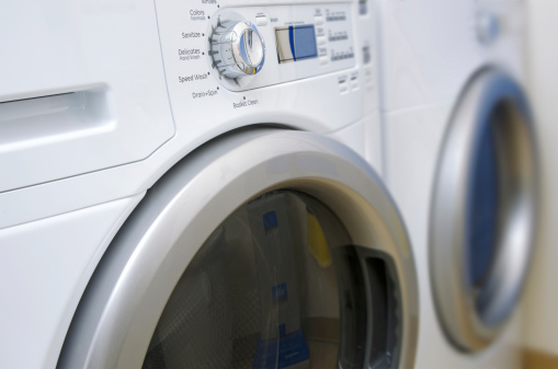 Close up view of a modern, front loading, clothes washer and dryer.