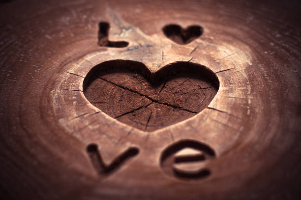Valentine's Day Concept background with Kopyspase. Love and heart on wooden background. carving.