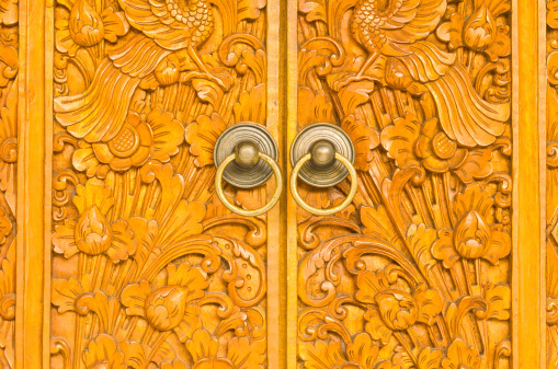 wooden door of country house with carved ornament, Bali Indonesia