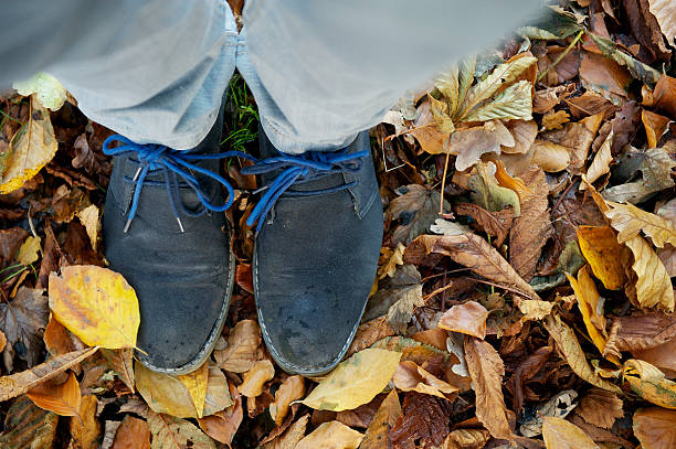 istock Standing on brown autumn leaves from above 478395081