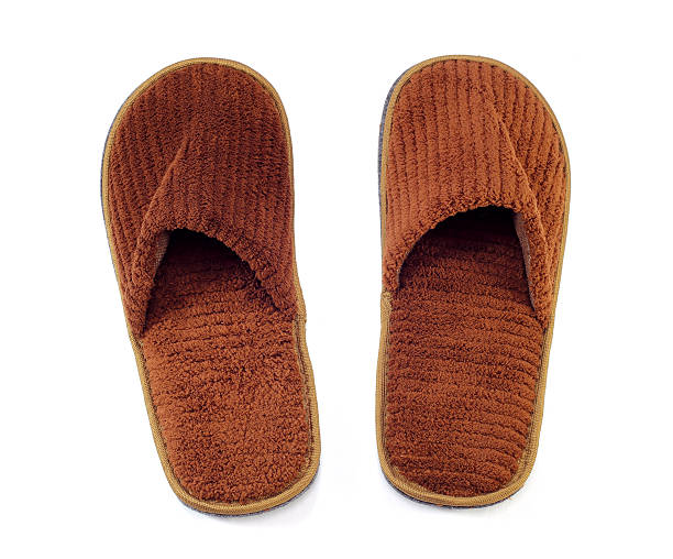 istock brown home slippers on white background 478395388