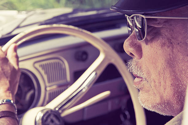 istock Older man with glasses driving a car 478395474