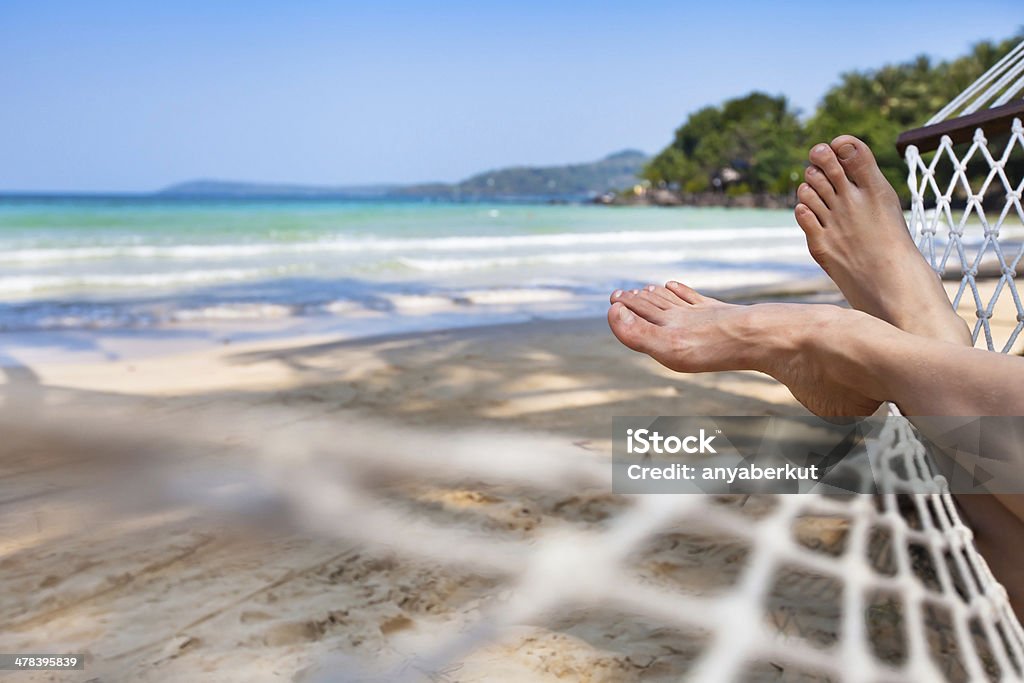 feet in hammock woman feet in hammock on the beach Beach Stock Photo