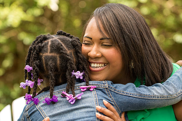 istock Mother laughing and hugging her daughter 478398706