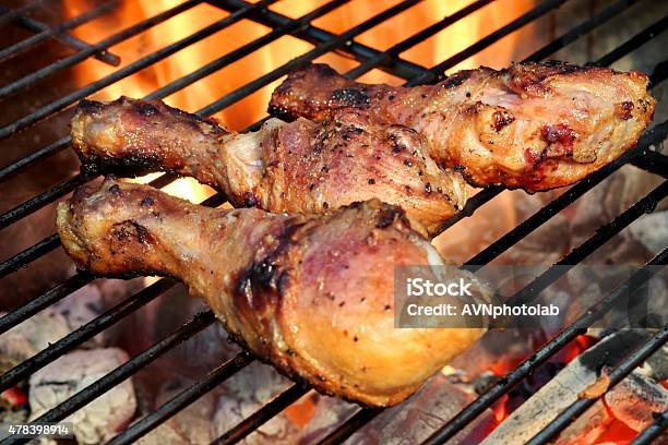 Closeup Of Bbq Chicken Legs On The Hot Flaming Grill Stock Photo - Download Image Now