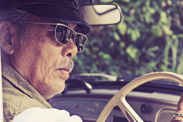 istock Older man with glasses driving a car 478399536
