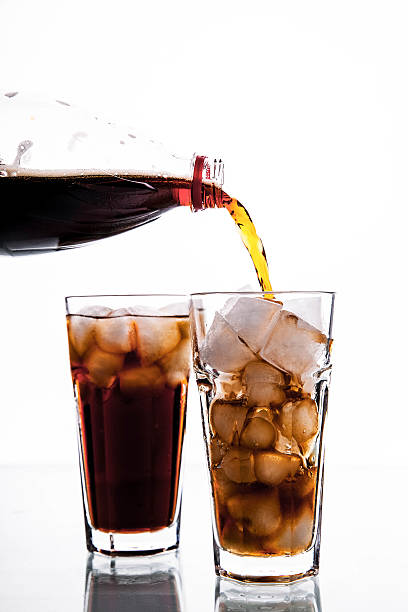 istock Cola is pouring into glass on white background. soft drinks 478399630