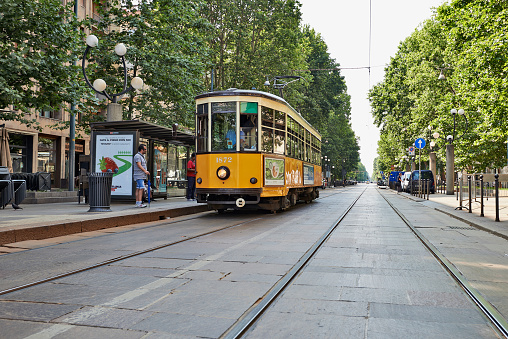 Budapest, Hungary - August 18, 2023: A train runs along a street near the Parliament in Budapest.