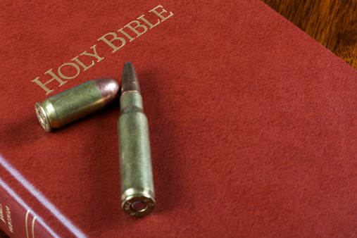 Two rounds of ammunition on a closed bible.