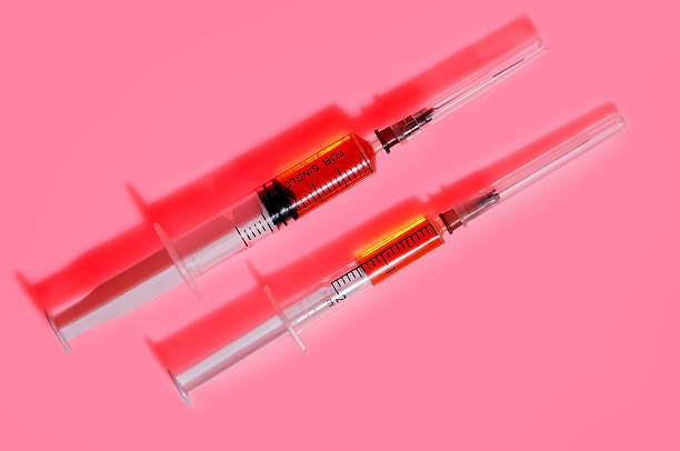 istock Two plastic disposable syringes with red medicine 478403622