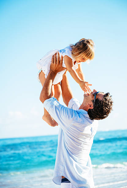 istock Father and daughter playing together at the beach 478403755