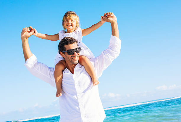 istock Father and daughter playing together at the beach 478403781