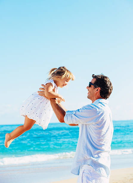 istock Father and daughter playing together at the beach 478403821