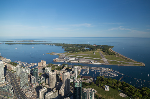 Toronto, Canada - June 6, 2015: A view towards towards Toronto Island Airport (Billy Bishop). Buildings and part of the Gardiner can be seen.