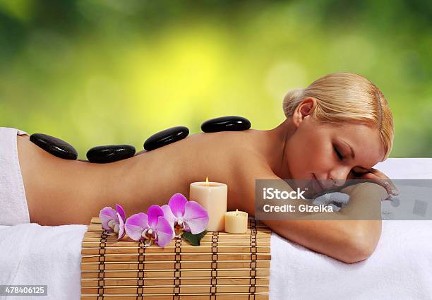 Spa Stone Massage Beautiful Blonde Woman Getting Hot Stones Massage Stock Photo - Download Image Now