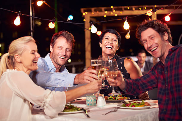 istock Group of friends eating dinner at rooftop restaurant 478406808