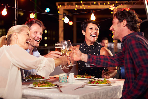 istock Group of friends eating dinner at rooftop restaurant 478406812