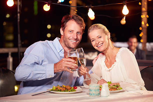 istock Couple eating dinner at rooftop restuarant 478406848