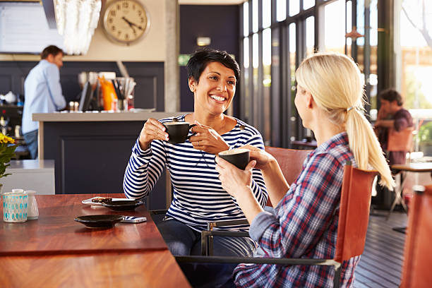 istock Two female friends talking at a coffee shop 478406952