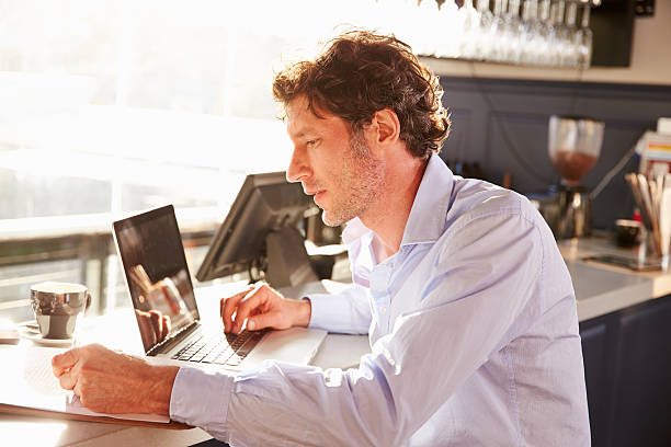 istock Male restaurant manager working on laptop 478407468