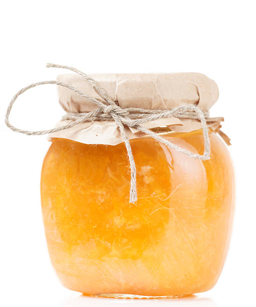 istock Orange jelly in glass jar isolated on white 478409025