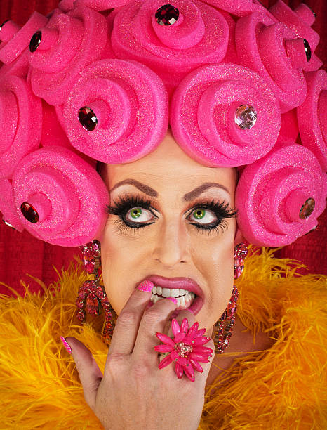 Man in Drag Biting Fingernails Nervous drag queen in pink wig biting nails nail biting stock pictures, royalty-free photos & images