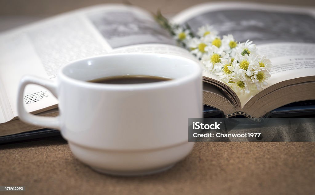 Flower on a book with a cup of coffee. Flower on a book with a cup of coffee,on cork board. Autumn Stock Photo